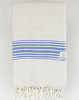 Folded beige linen scarf with a cotton blend and blue colour stripes.