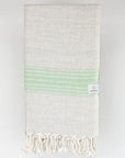 Folded beige linen scarf with a cotton blend and green colour stripes.