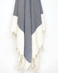 Diamond pattern cotton scarf in navy colour with knotted fringe hanging.