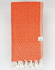 Folded Cotton scarf in orange colour in a 'gentle wave' pattern.