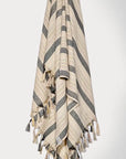 Towel with thin and thick colourful vertical stripes and hand twisted & knotted fringe hanging.