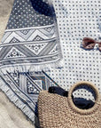 Stylish photo-shooting of the double-sided a black colour towel with jacquard patterns.
