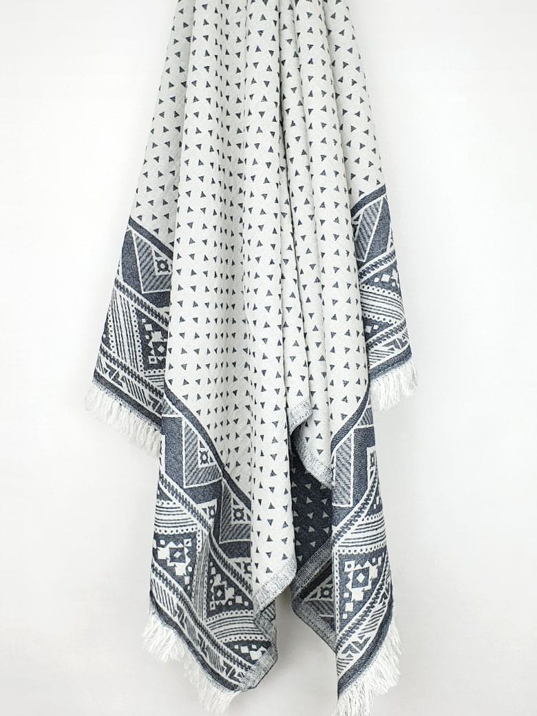 Double-sided towel a black colour with jacquard patterns hanging.