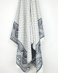 Double-sided towel a black colour with jacquard patterns hanging.