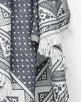 Close-up image of a double-sided a black colour towel with jacquard patterns.