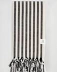 Folded large towel with black thick stripes colour.