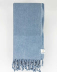 Folded beach towel in plain grey colour.