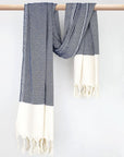 Diamond pattern towel in navy colour with knotted fringe and hand-twisted style on the stick.