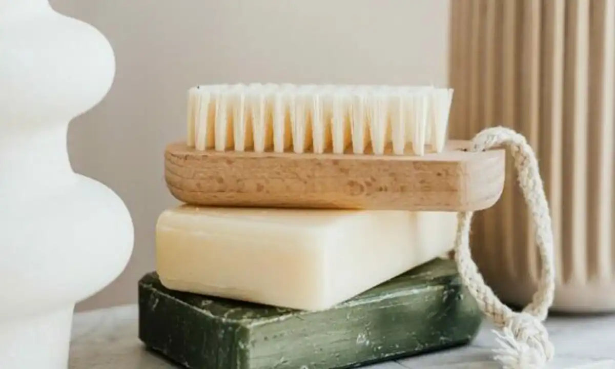a soft bath brush, white soap & green soaps