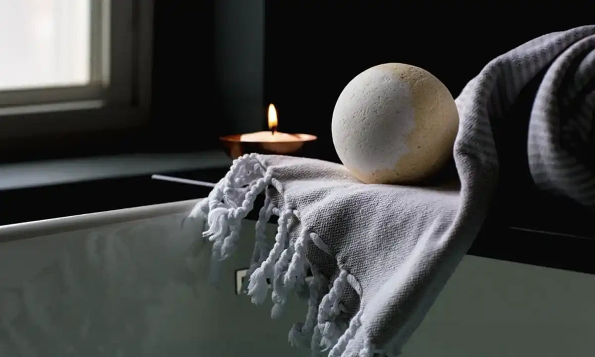 Hammam towel, bath bomb & candle in the bathroom.