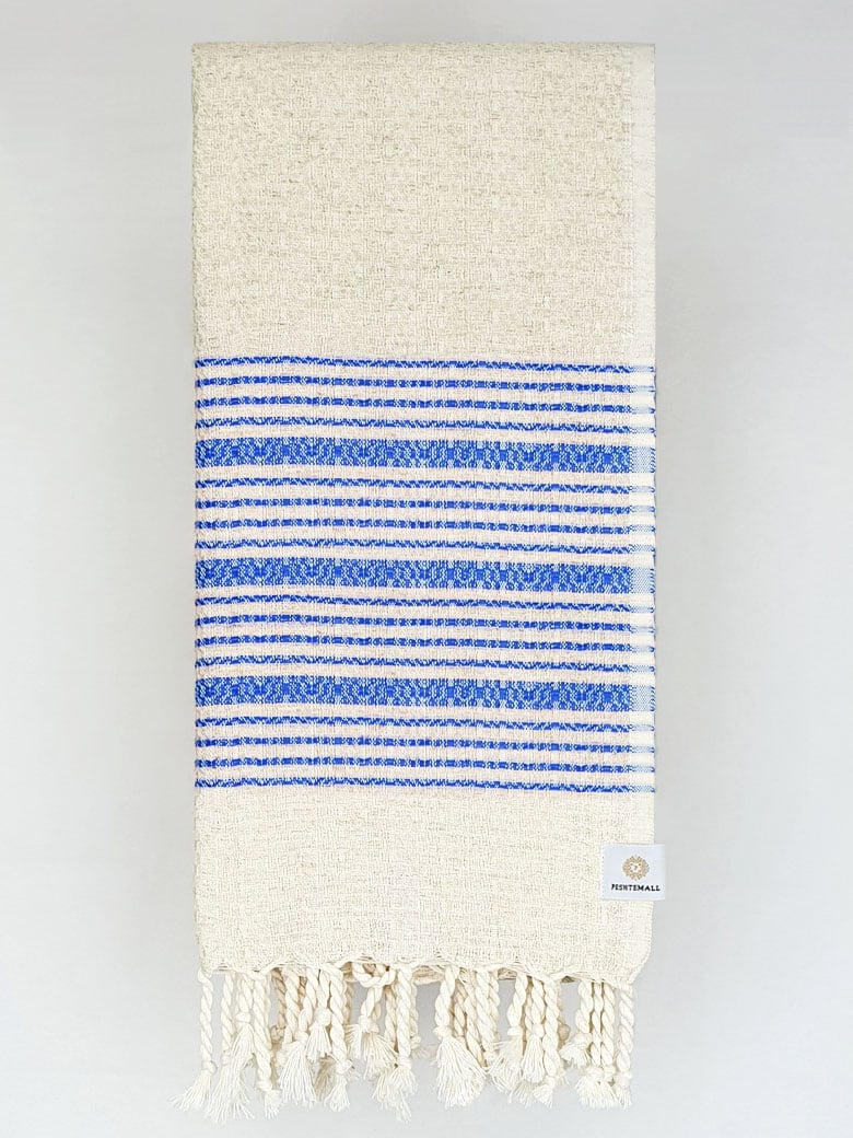 Folded blue colour with multiple stripes on a plain beige colour.