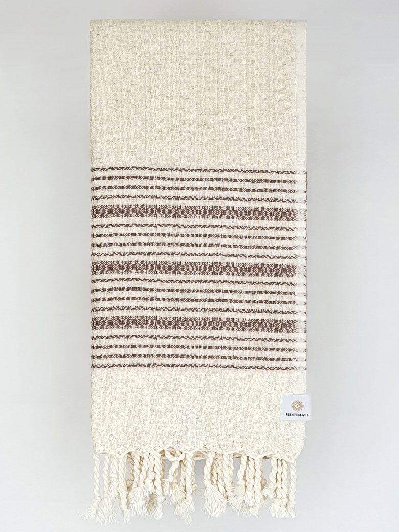 Folded brown colour with multiple stripes on a plain beige colour.