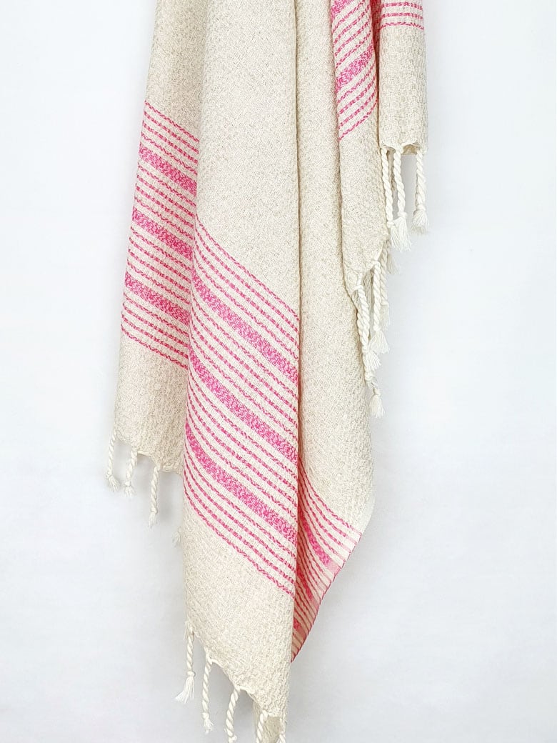 Pink colour with multiple stripes on a plain beige colour hanging.