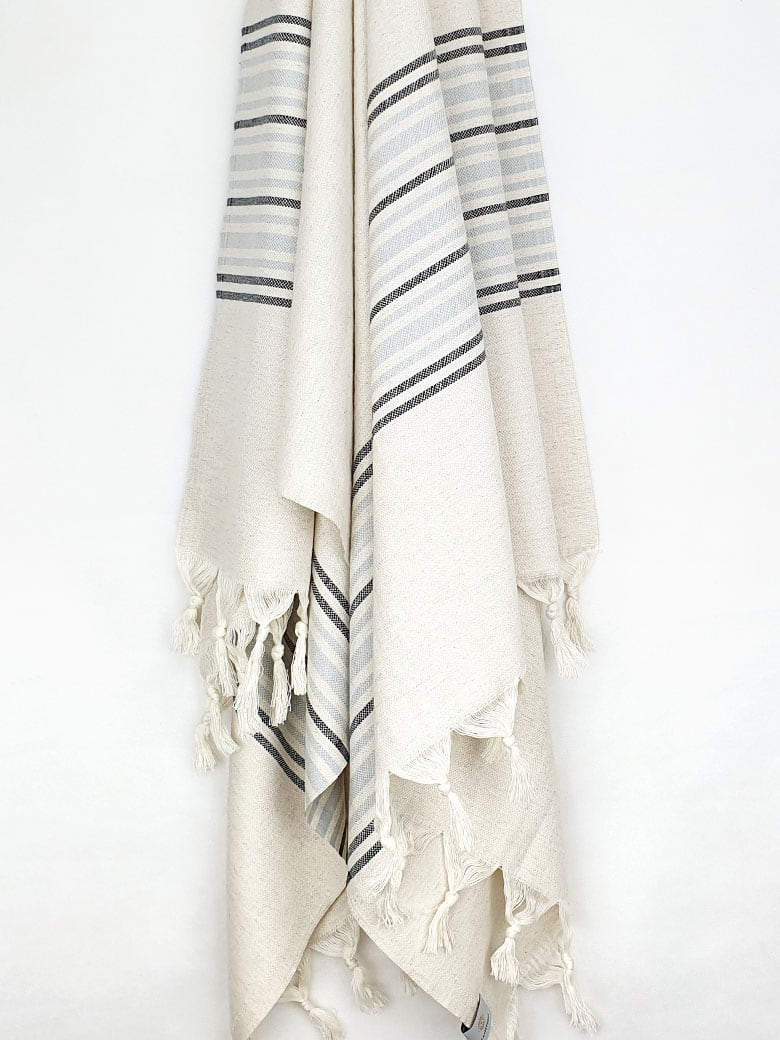 Grey stripes on a cream colour plain colour with linen & cotton blends with knotted fringe hanging.