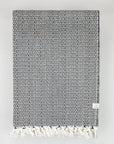 Folded 100% cotton blanket with a unique pattern in black & white colour.