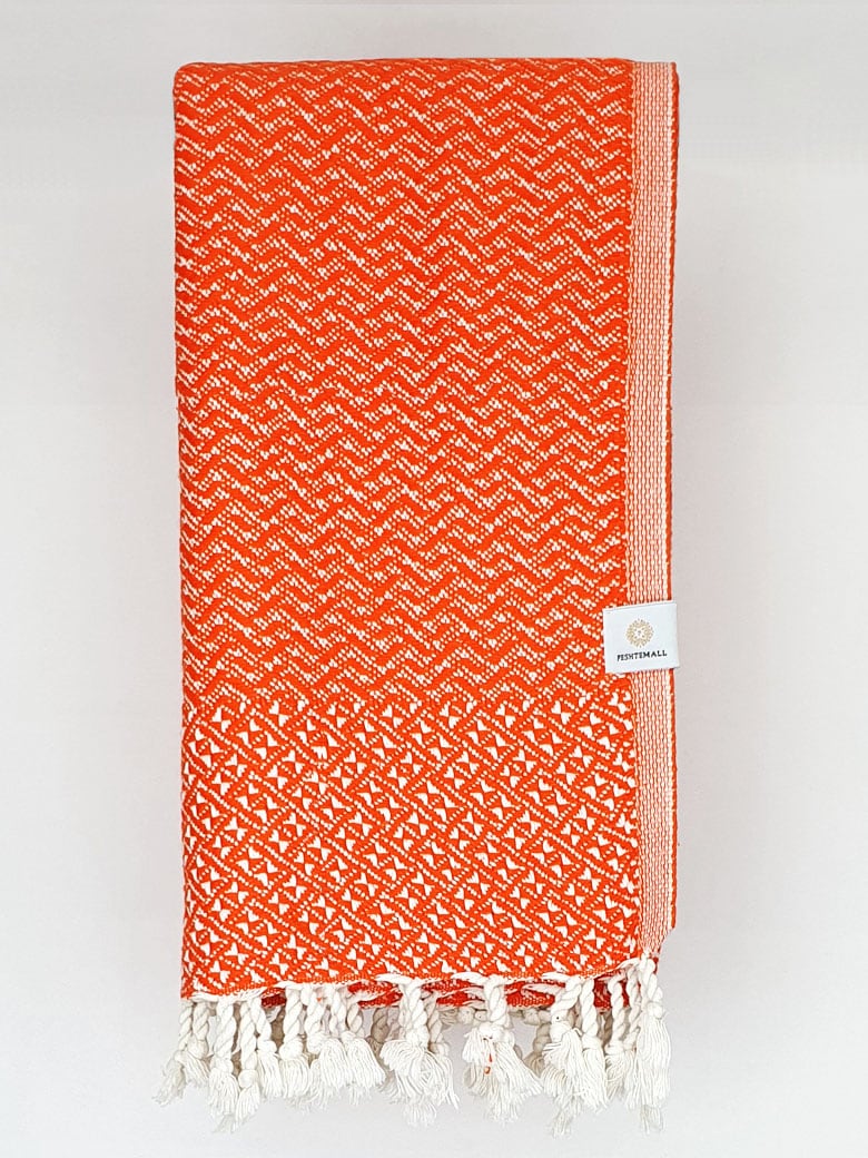 Folded Cotton scarf in orange colour in a 'gentle wave' pattern.