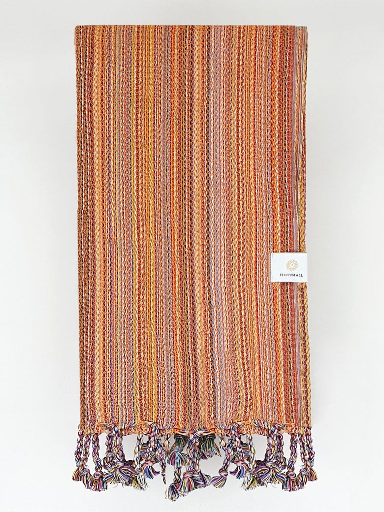 Folded crochet scarf with a blend of orange colours.