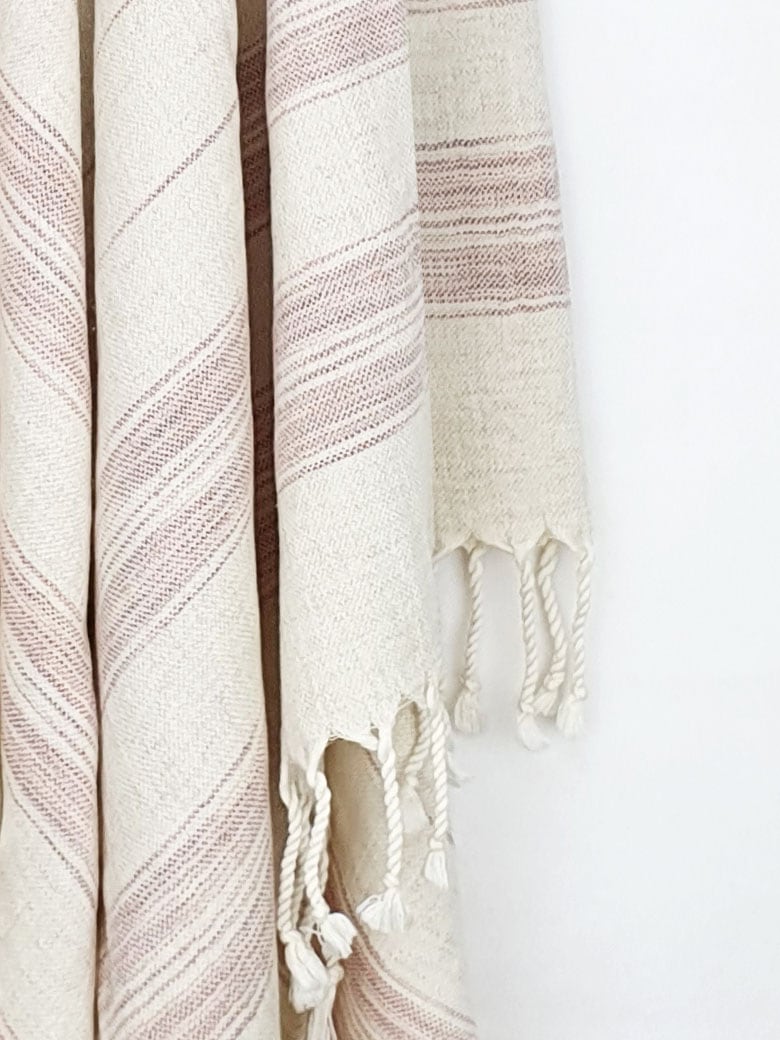 Close-up image of a scarf with linen & cotton blend in brown colour with knotted fringe.