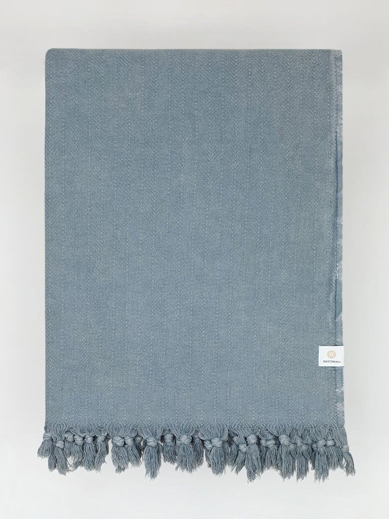 Folded strong cotton blanket with a simple pattern in grey colour.