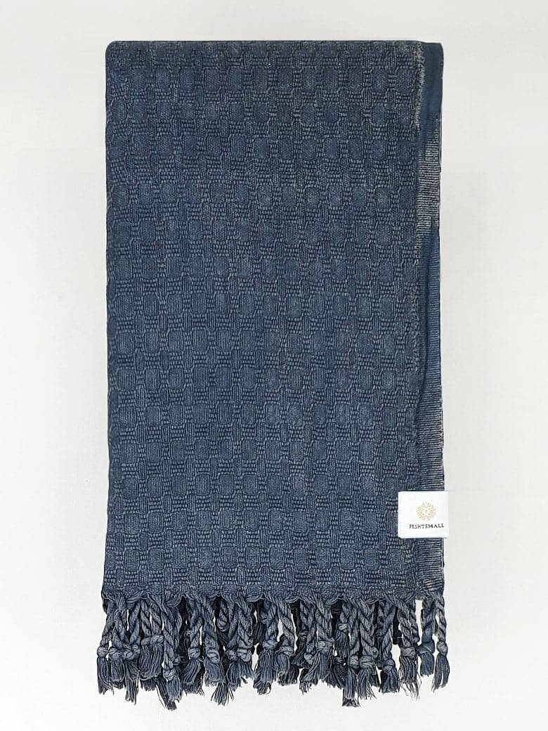 Folded cotton scarf is handwoven in plain dark grey colour.