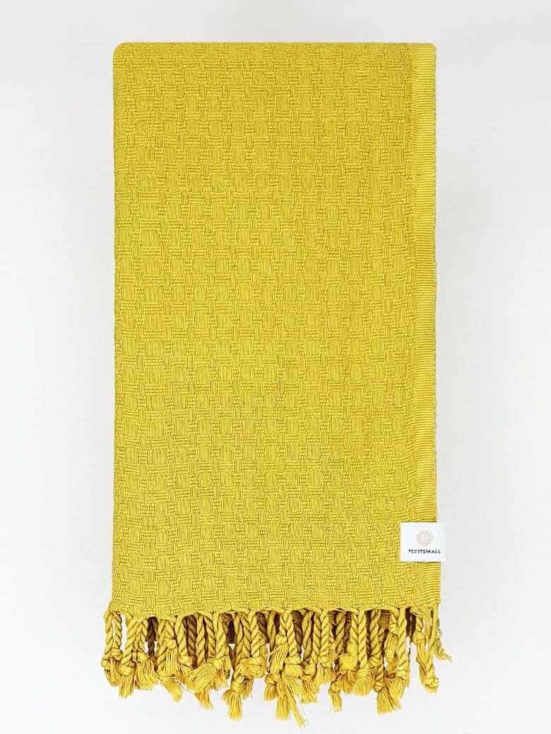 Folded cotton scarf is handwoven in plain mustard colour.