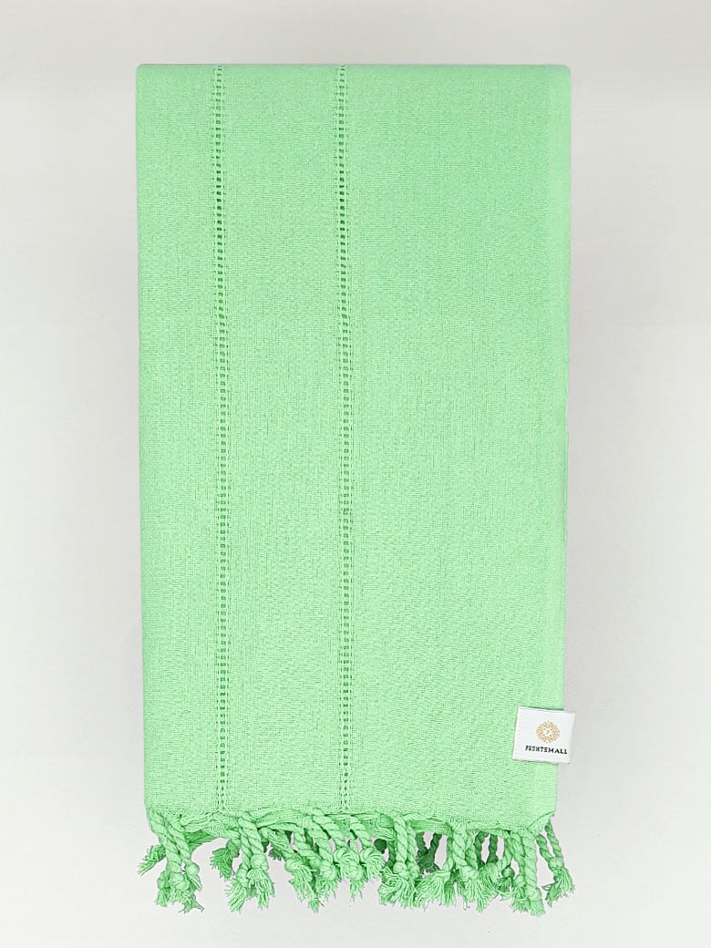 Folded cotton scarf in plain green colour.