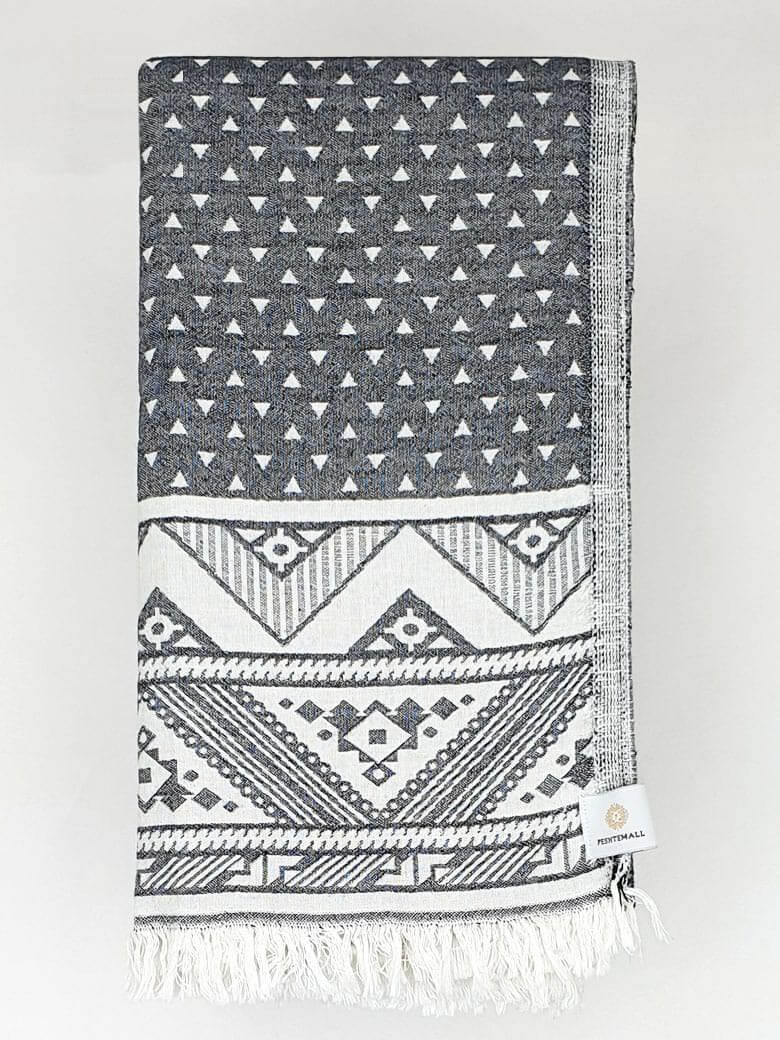 Folded double-sided a black colour towel with jacquard patterns.