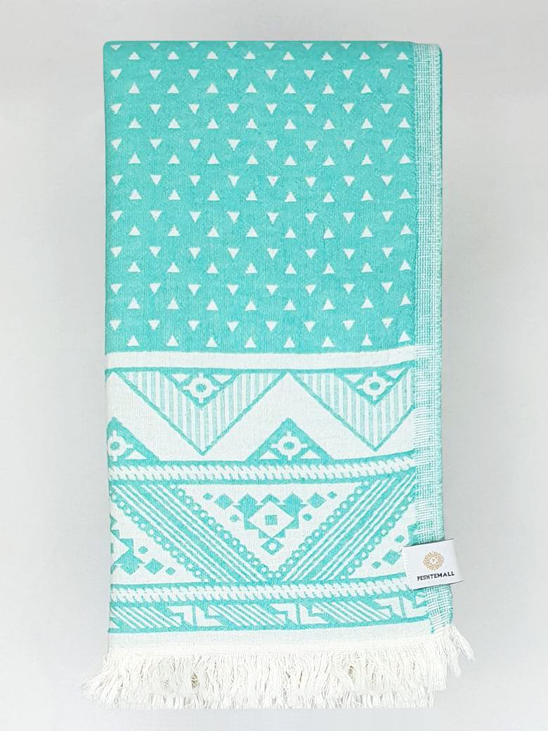 Folded double-sided a mint colour towel with jacquard patterns.