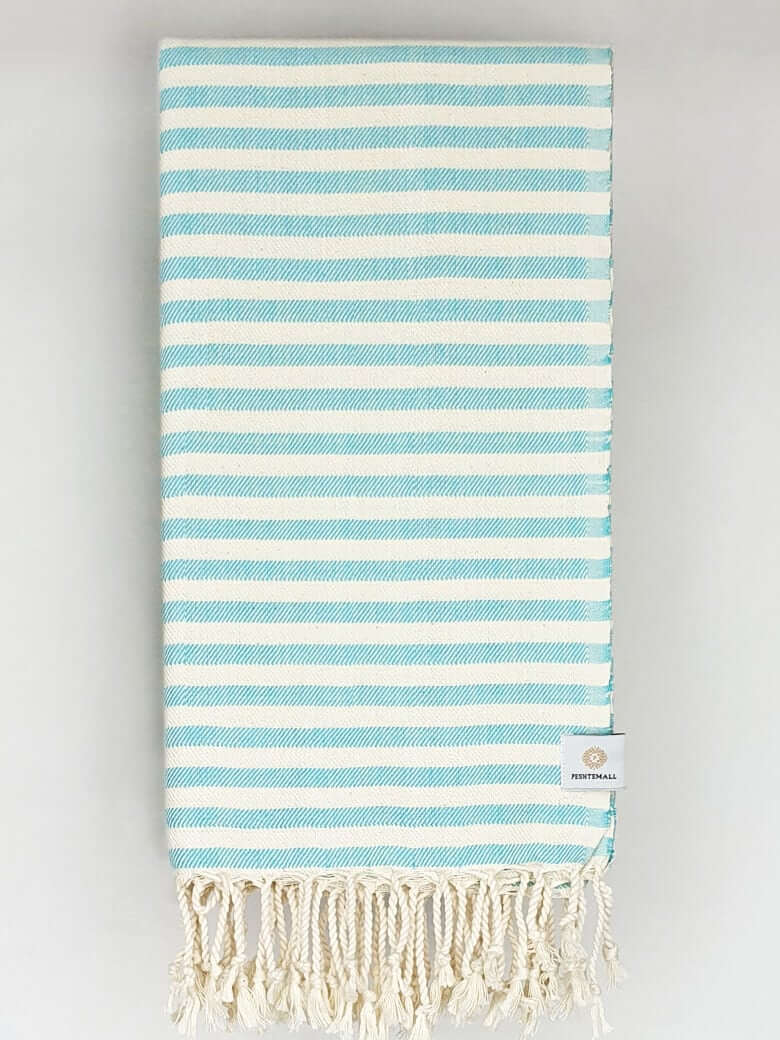 Folded cotton towel in plain aqua colour.