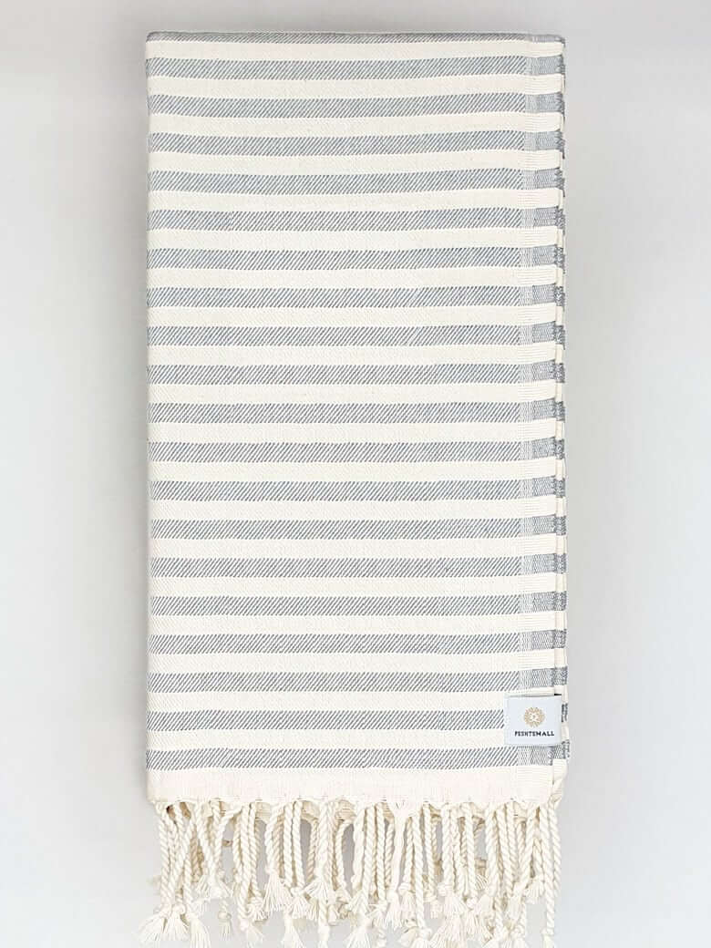 Folded cotton towel in plain grey colour.
