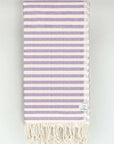 Folded cotton towel in plain lilac colour.