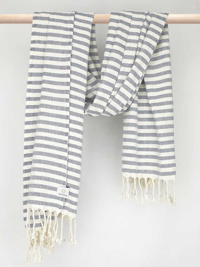 Cotton towel with navy stripes and hand-twisted style on the stick.