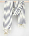 Cotton towel with navy stripes and hand-twisted style on the stick.