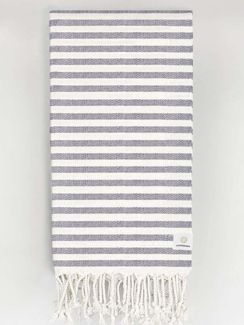 Folded cotton towel in plain navy colour.