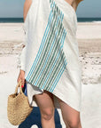 Stylish photo-shooting of cotton & linen towel with green stripes & knotted fringe on the beach.