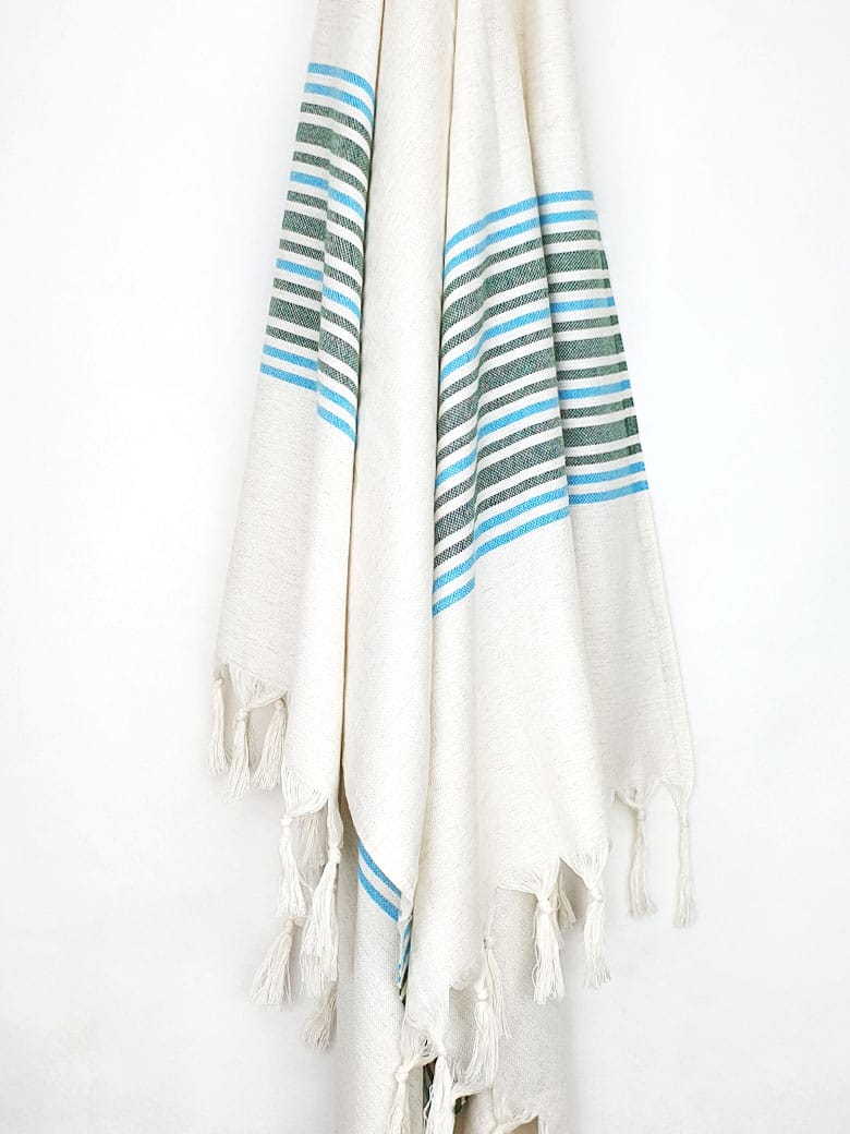 Close-up image of cotton & linen towel with green stripes & knotted fringe.