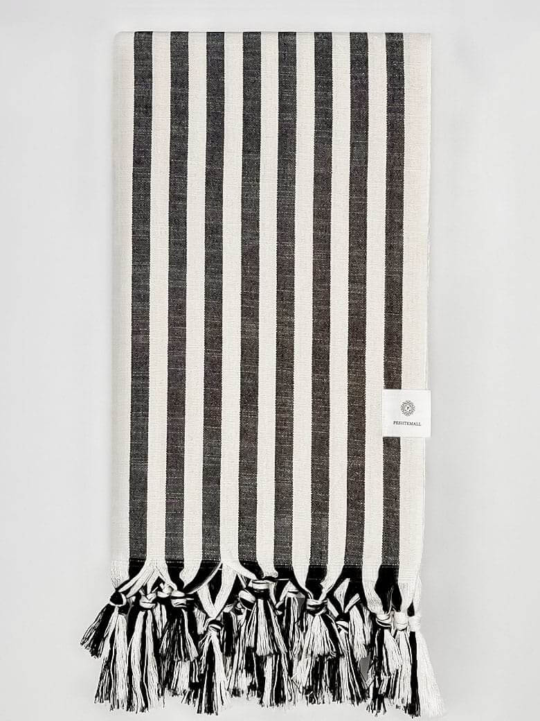 Folded large towel with black thick stripes colour.