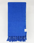 Folded beach towel in plain blue colour.