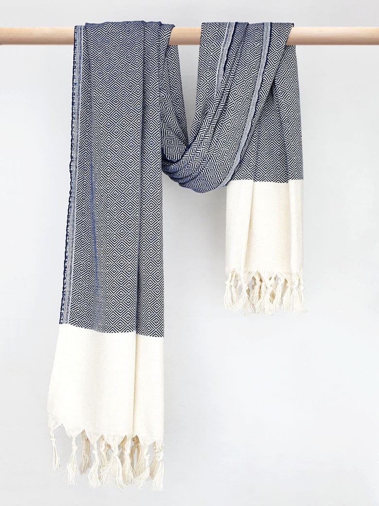 Diamond pattern towel in navy colour with knotted fringe and hand-twisted style on the stick.