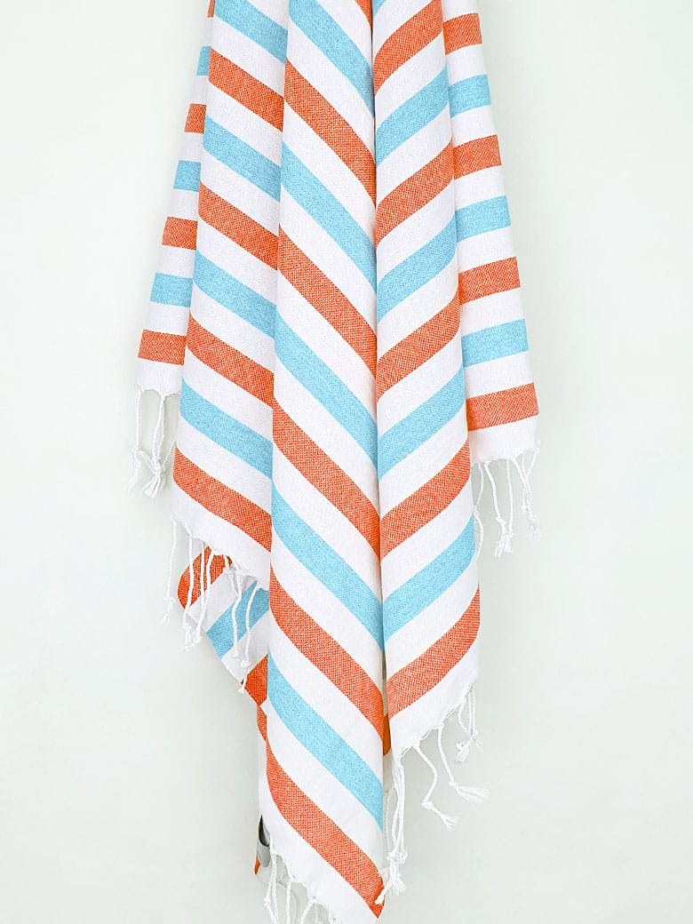 Towel with orange &amp; blue horizontal stripes and hand-twisted &amp; knotted fringe hanging.