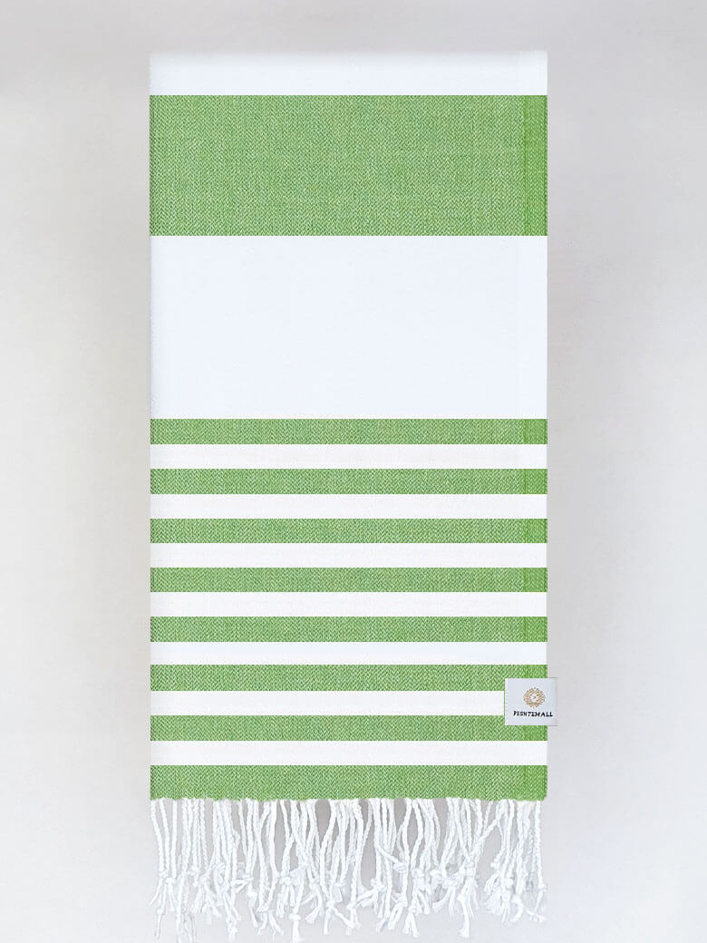 Folded beach towel with green and white colours stripes and hand-twisted &amp; knotted fringe.