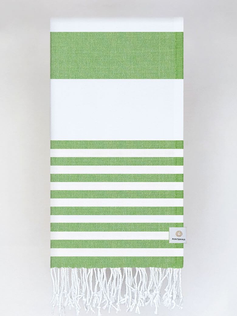 Folded beach towel with green and white colours stripes and hand-twisted & knotted fringe.