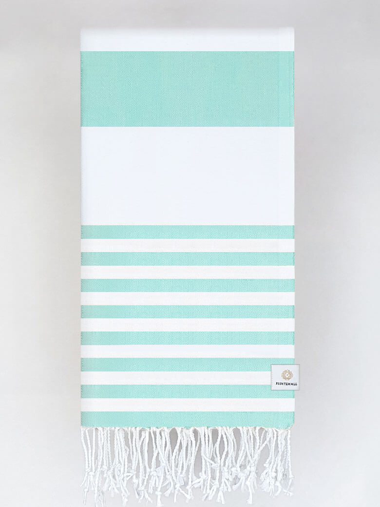 Folded beach towel with mint and white colours stripes and hand-twisted & knotted fringe.