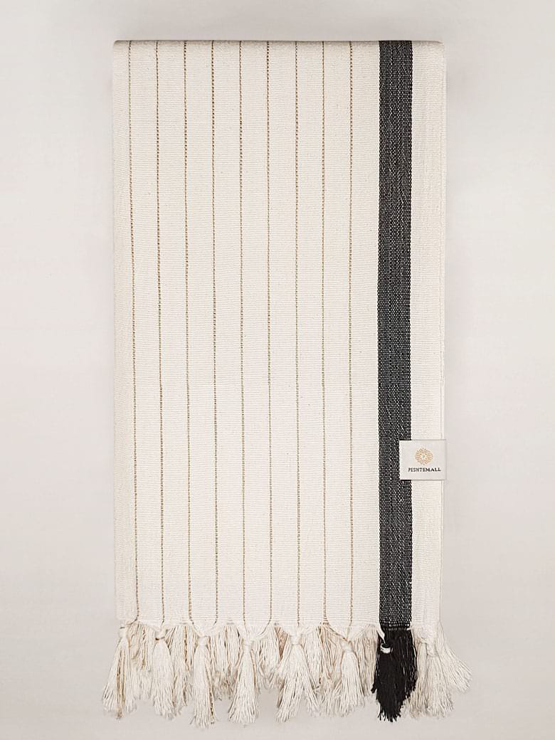 Folded towel with black stripes on beige colour and knotted fringe.