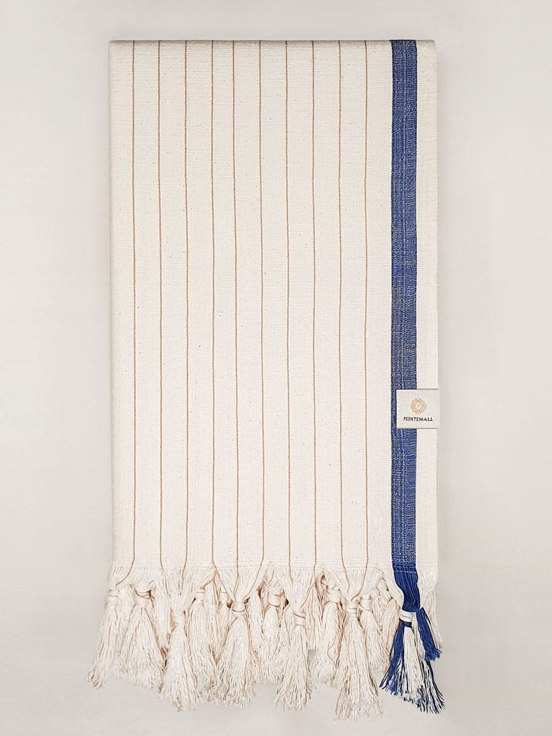 Folded towel with navy stripes on beige colour and knotted fringe.