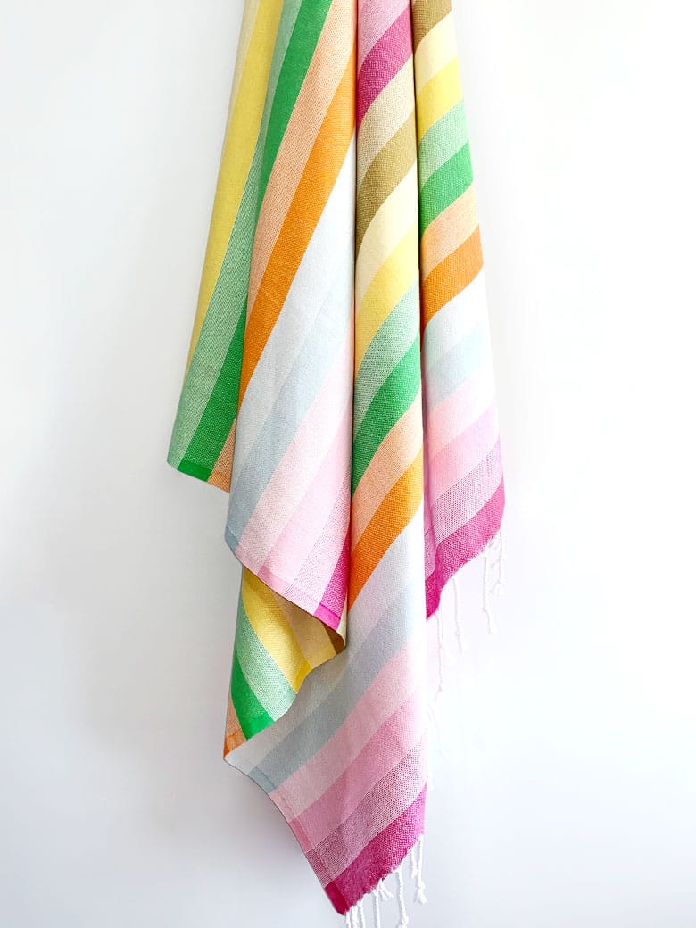 Towel with thick colourful stripes and hand twisted &amp; knotted fringe hanging.