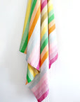 Towel with thick colourful stripes and hand twisted & knotted fringe hanging.