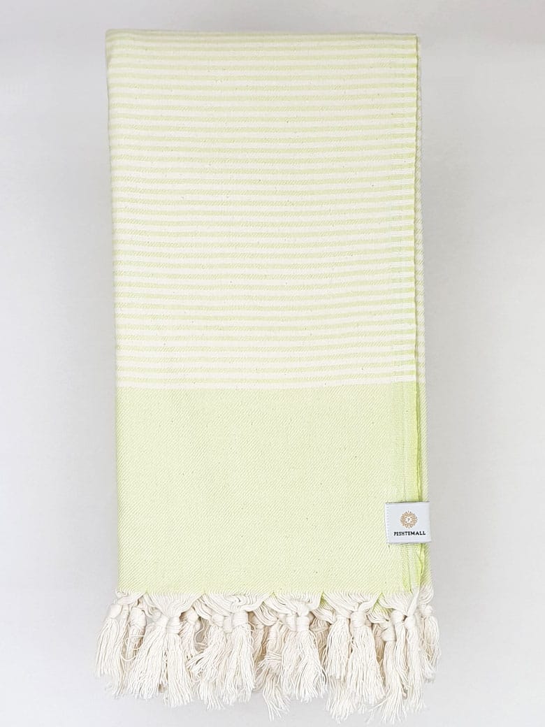 Folded a bitter lemon colour towel with white stripes and knotted fringe.