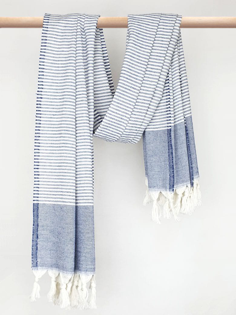 Denim colour towel with white stripes and knotted fringe with hand-twisted style on the stick.