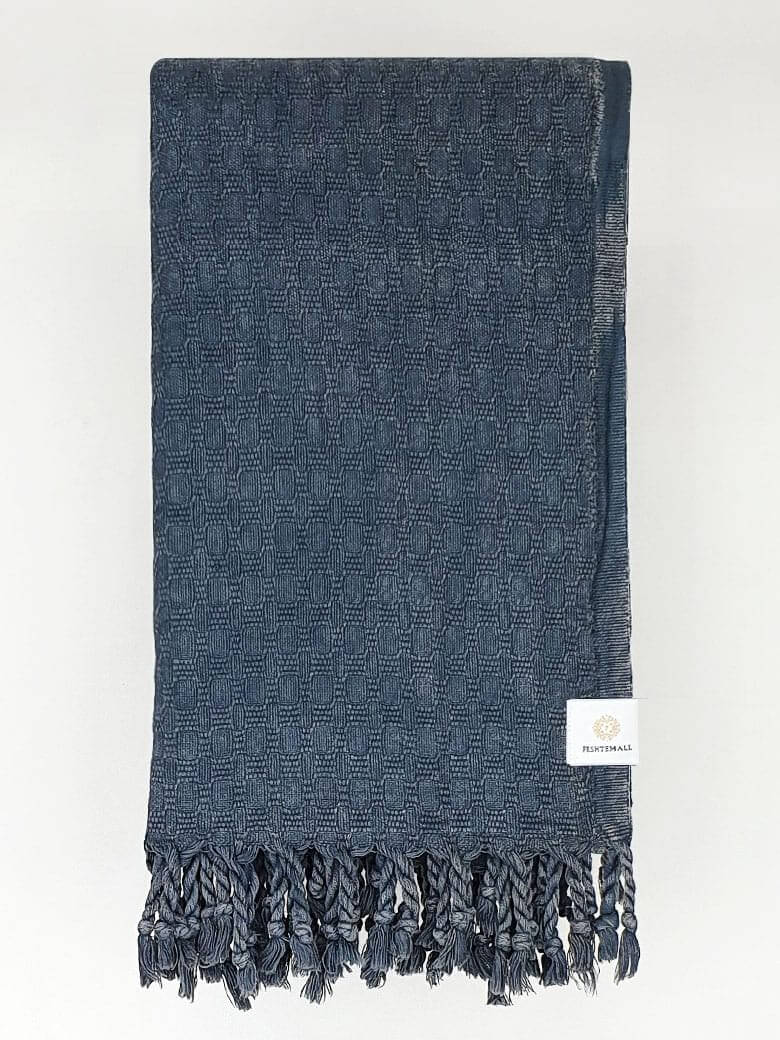 Folded towel in plain dark grey colour.